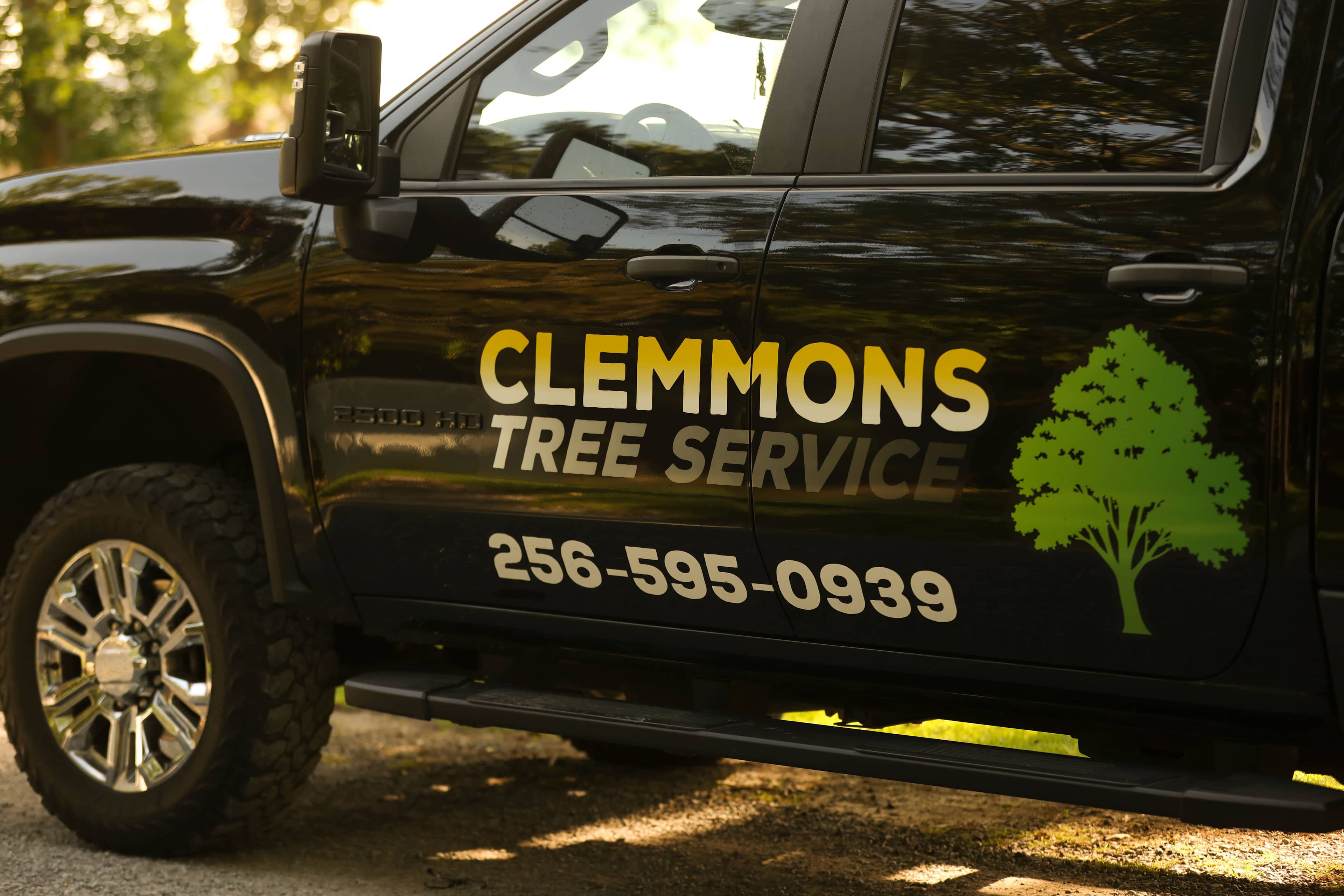 The Clemmons Tree Service truck parked at a job site in Cullman, Alabama — the free on-site visit that produces an accurate tree removal cost for your property